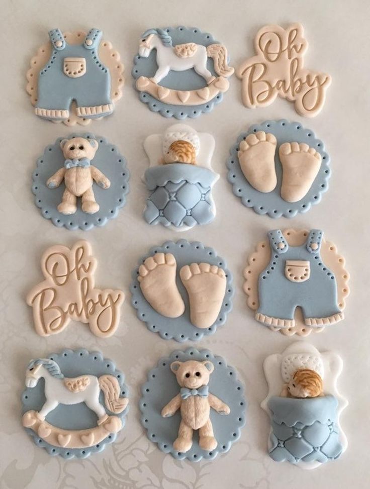 baby shower cookies are arranged on a table