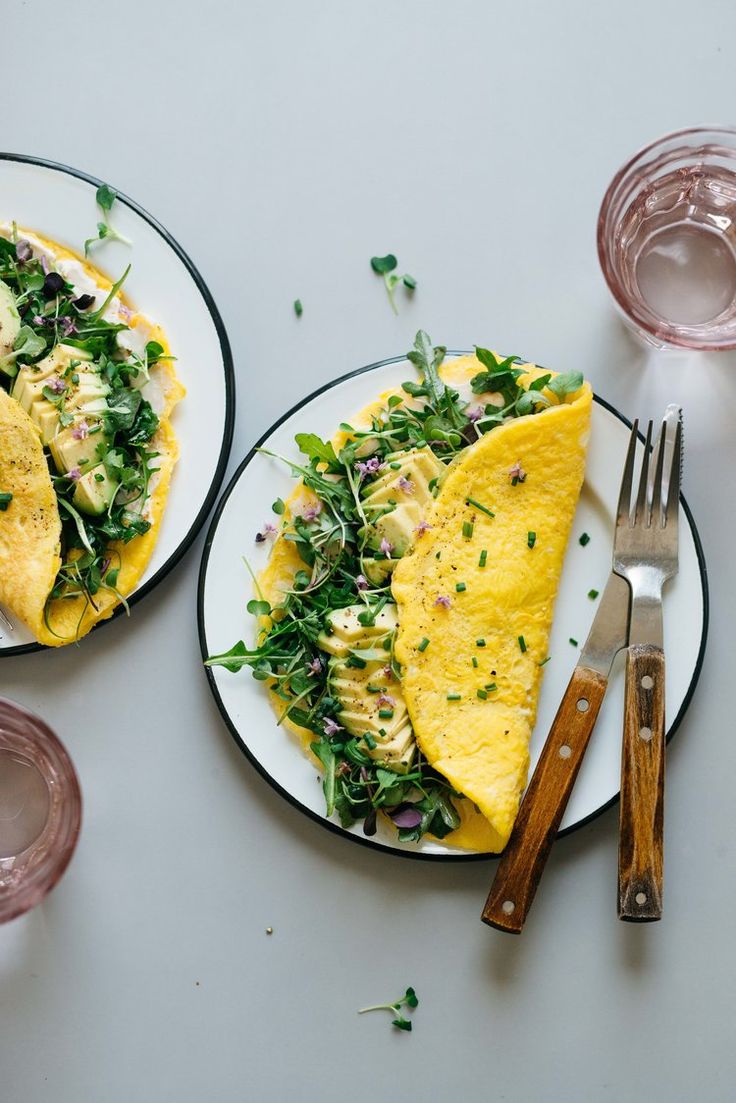 two white plates topped with food next to each other