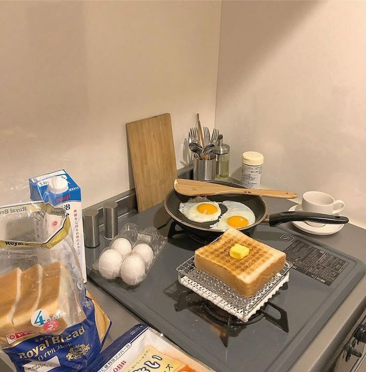 the breakfast is on the stove ready to be cooked in the oven, and eggs are being prepared