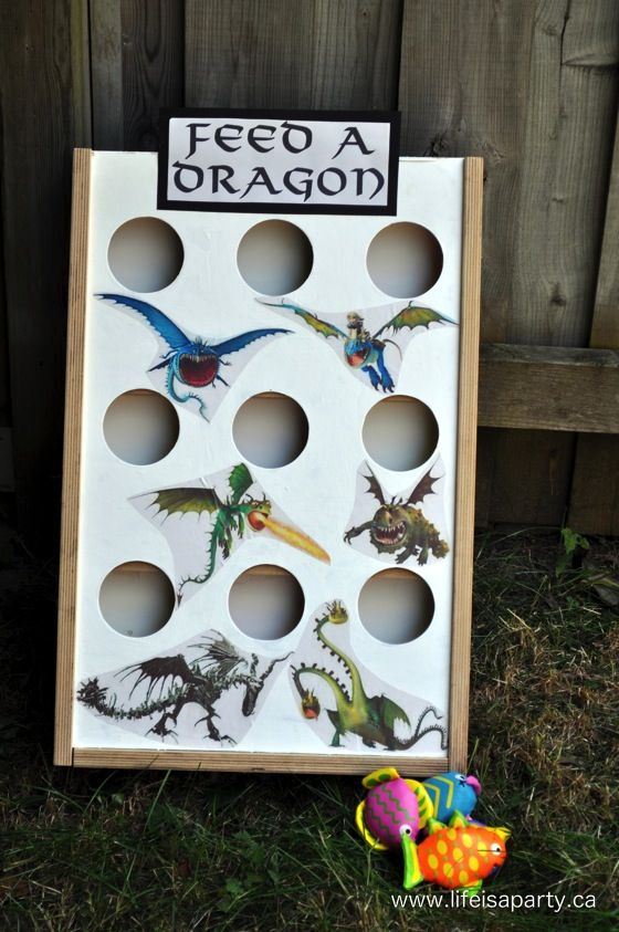 a game board with several different types of birds and insects on it sitting in the grass next to a fence