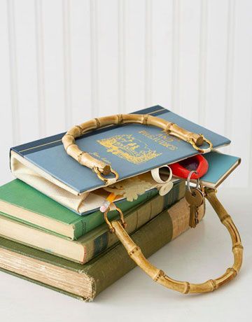 several books stacked on top of each other with a bamboo bag attached to the front