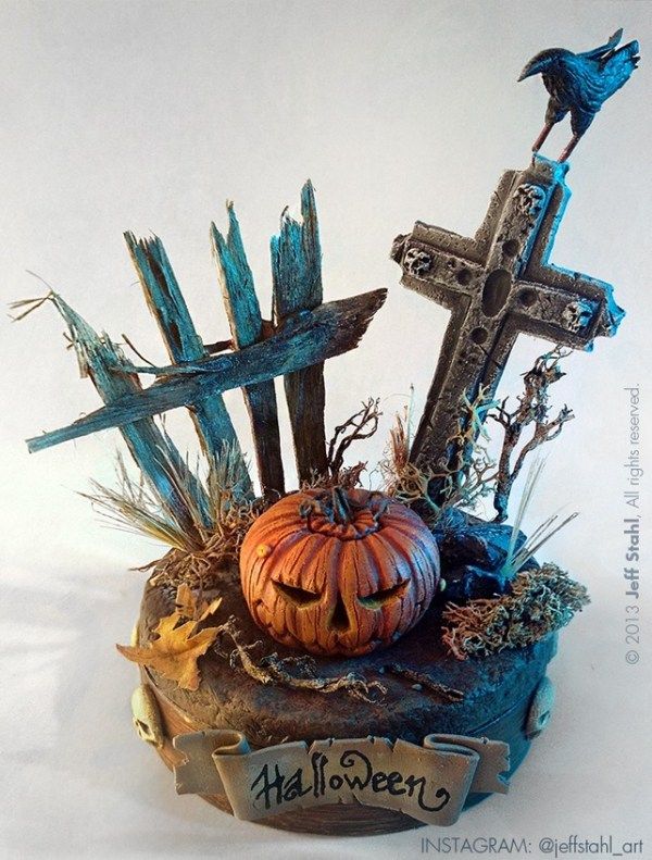 a halloween decoration with a pumpkin and cross