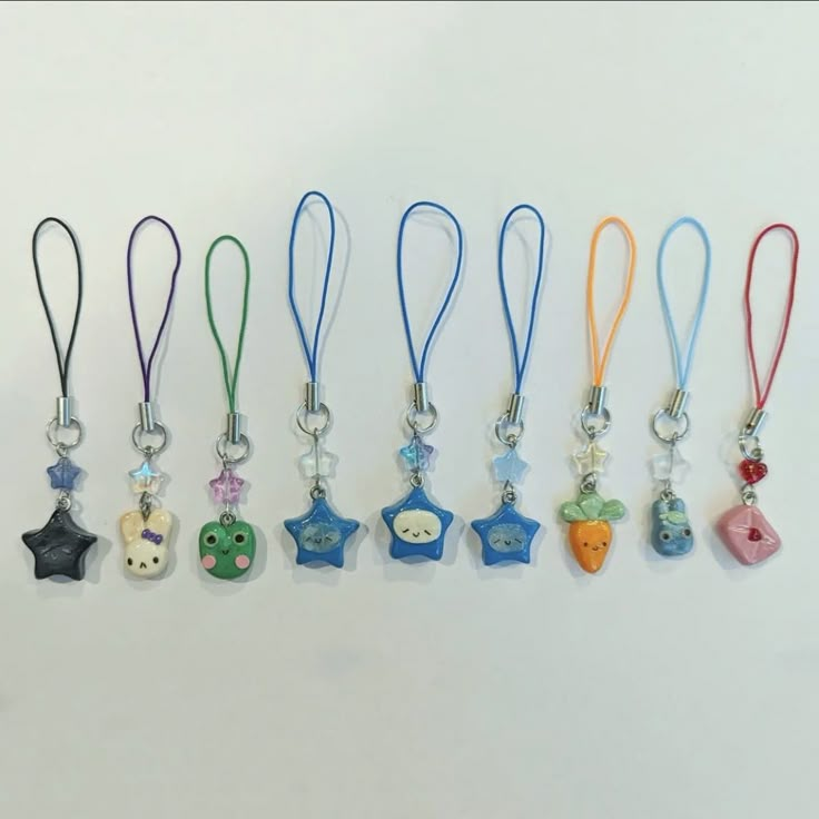 a row of key chains with different colored charms