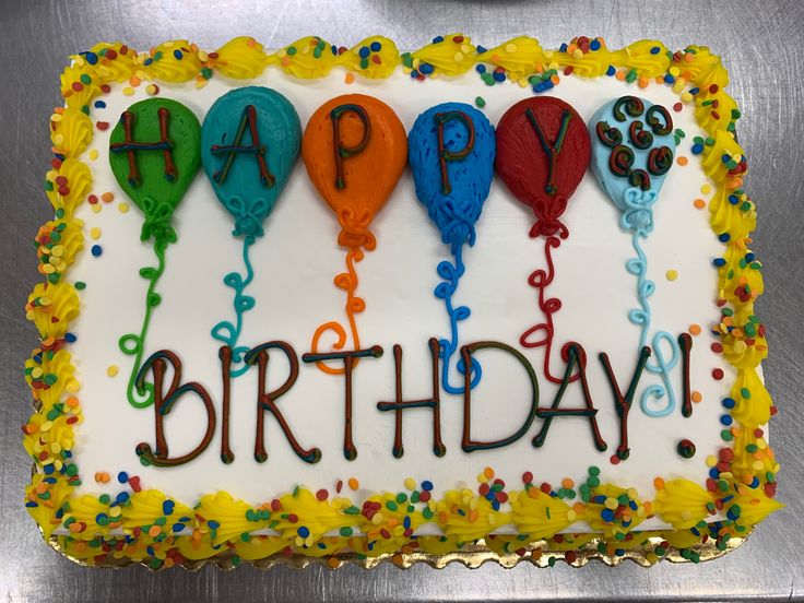 a birthday cake with balloons and confetti on it