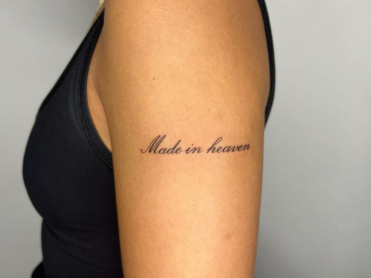 a woman with a tattoo on her arm that says made in heaven