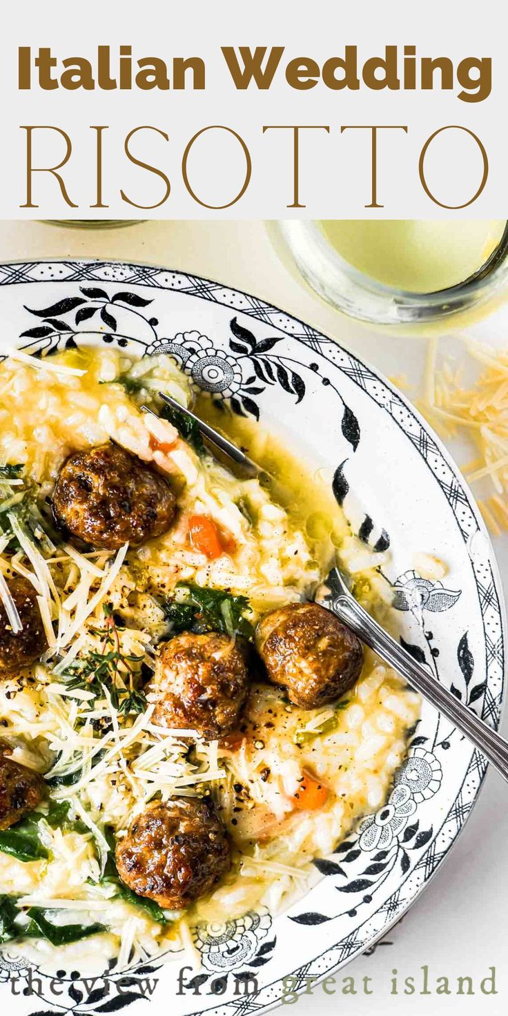 a white plate topped with meatballs covered in grated cheese next to a glass of wine