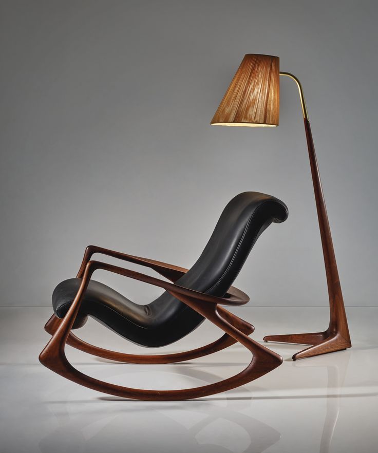 a modern rocking chair with a lamp on top