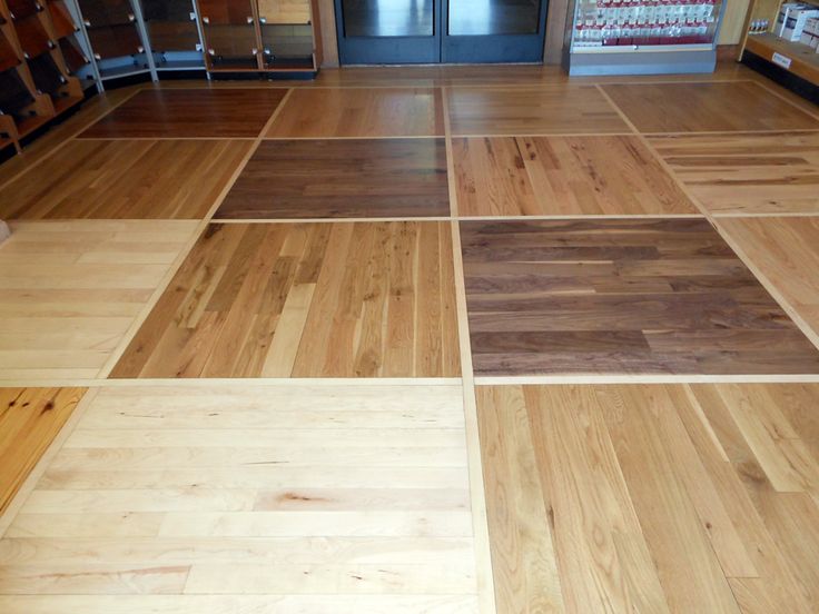 wood flooring with different colors and patterns in a store or retail area that is empty