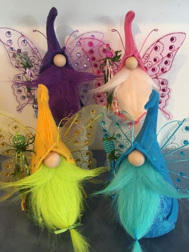 three fairy tinkerbells sitting next to each other on top of a table