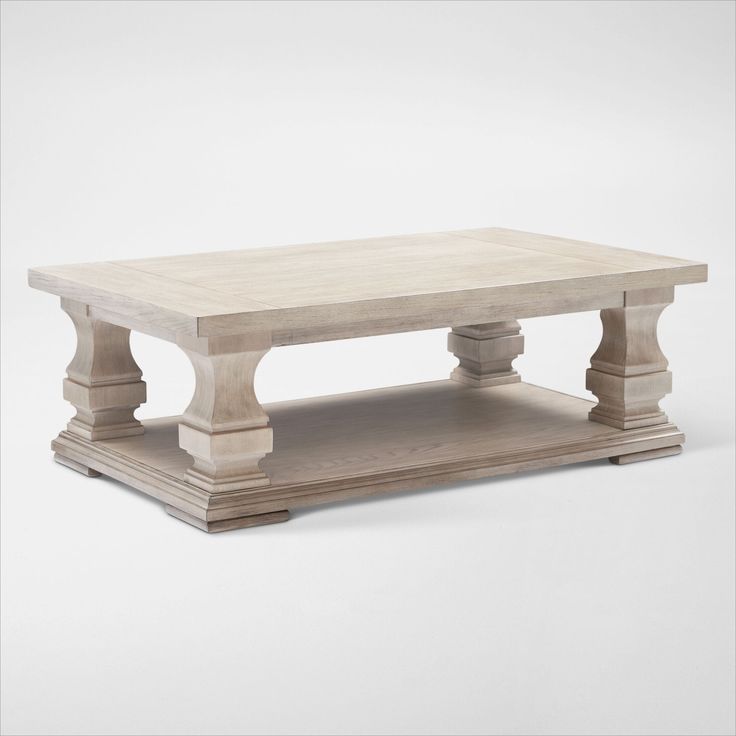 a white coffee table sitting on top of a wooden shelf