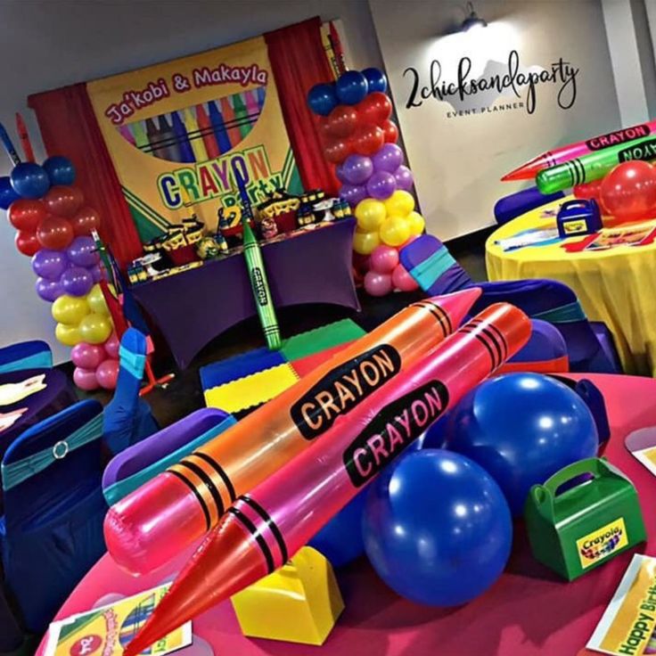 an assortment of toys and decorations on a table at a children's birthday party