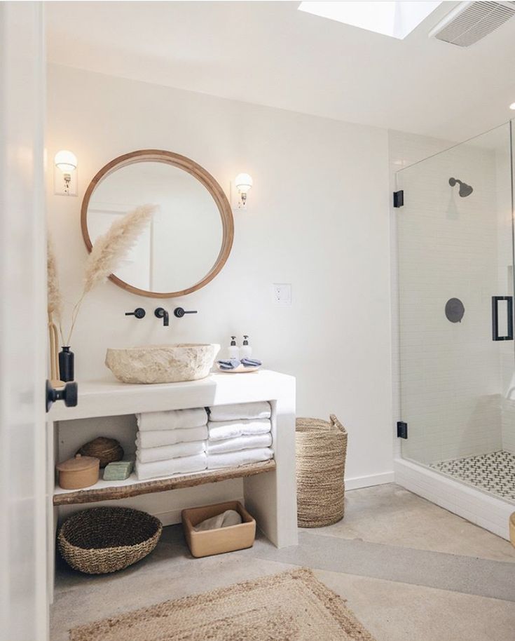 a bathroom with a sink, mirror and shower