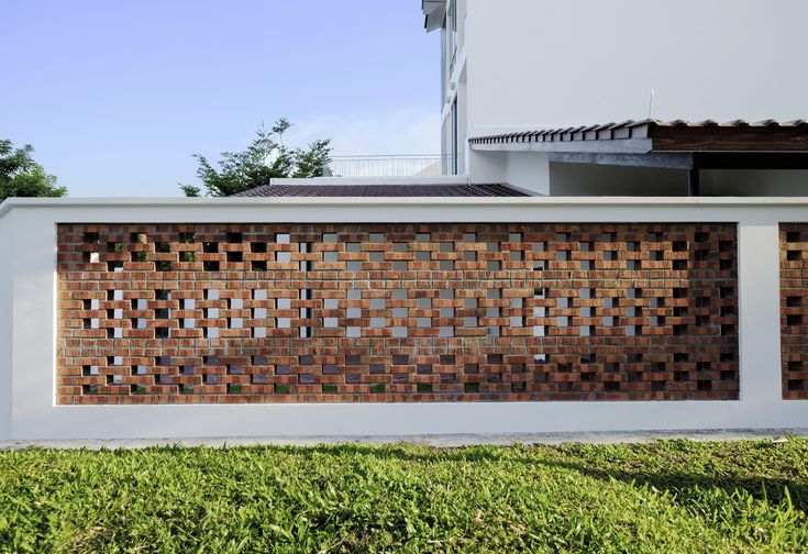 a white fence with brown bricks on it