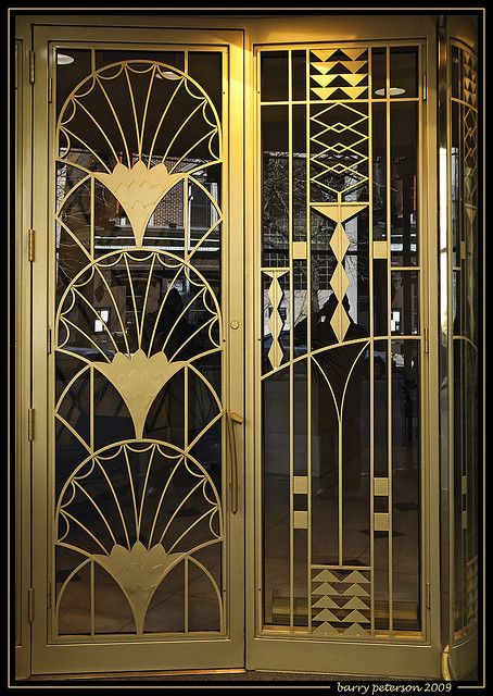 an ornate glass door with geometric designs on it