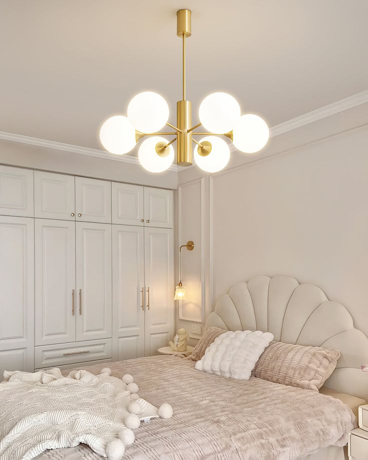 a bedroom with a large bed and lots of closets in the corner, along with a chandelier hanging from the ceiling