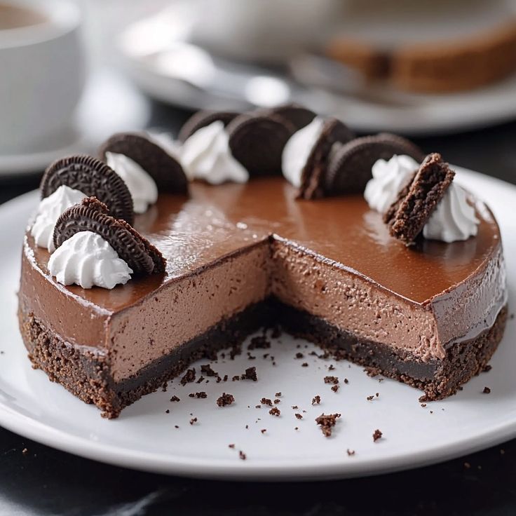 a chocolate cheesecake on a white plate with one slice cut out and ready to be eaten