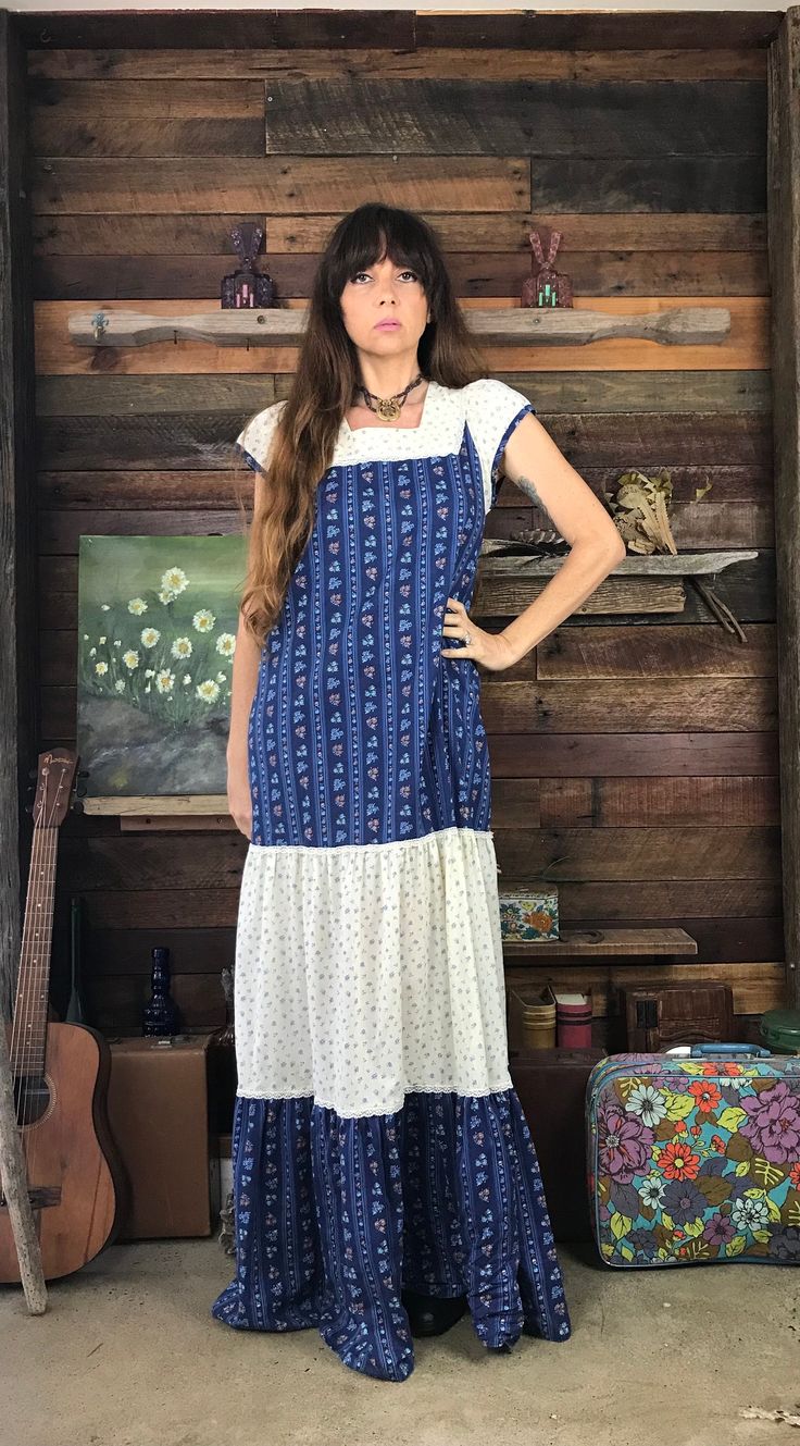 This pretty 1970's Prairie Maxi Dress features a square neckline and pretty puff capped sleeves.  It is made from soft blue and white floral fabric with a flowing, lace trimmed A line ankle length skirt.  It is in good vintage condition. Measurements: Length:  58.5" or 148cm Bust:  up to:  38" or 96cm Waist:  up to:  41" or 104cm Hips:  up to:  45" or 114cm Sleeve:  5" or 12.5cm All items are sold in laundered good or very good vintage condition.  Please check measurements and photos carefully and contact me with any questions. White Floral Fabric, Ankle Length Skirt, Blue And White Floral, Capped Sleeves, Style Expert, Floral Fabric, Dress Clothes For Women, Square Neckline, Festival Season