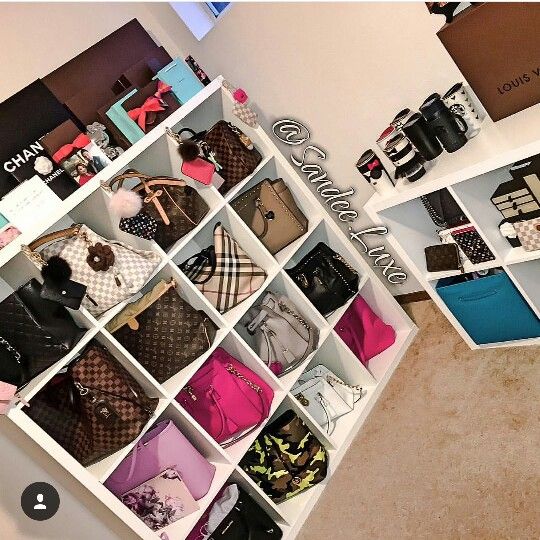 there are many purses on display in the closet