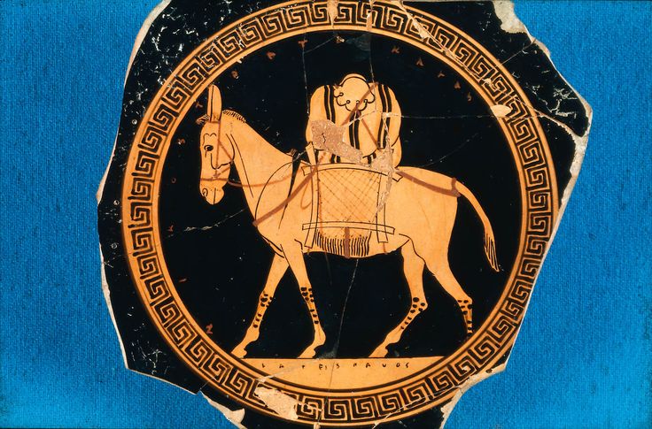 an ancient greek vase with a man riding a horse