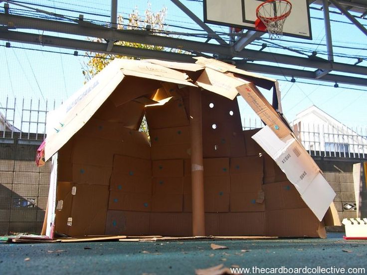 cardboard boxes are stacked on top of each other in front of a basketball hoop and net