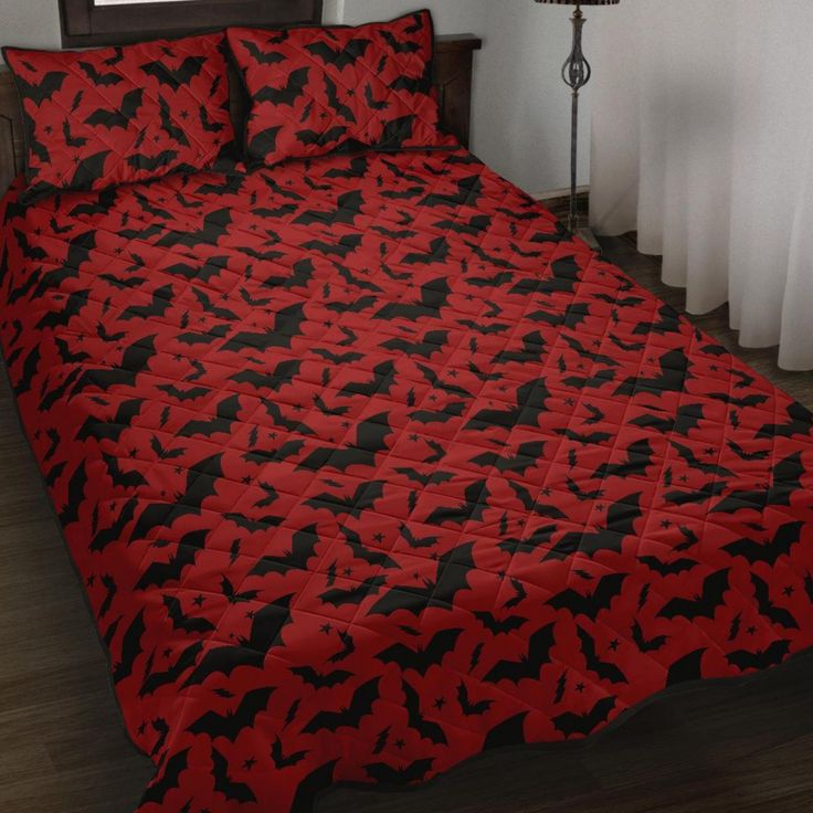 a bed covered in red and black bats