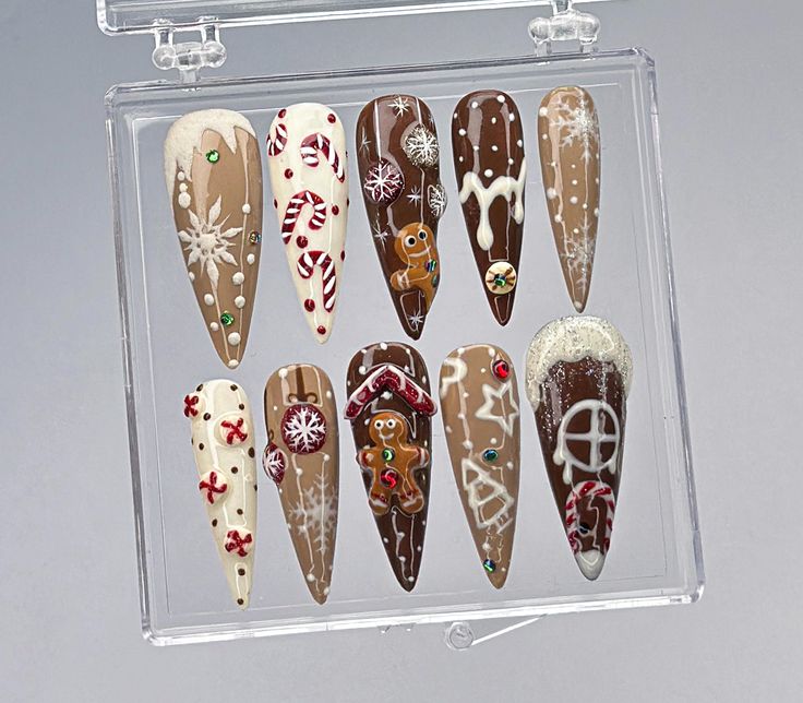 Embrace the warmth and sweetness of the holiday season with this adorable Gingerbread Christmas Press-On Nail Set! Each nail is carefully designed to capture the magic of Christmas with gingerbread houses, candy canes, snowflakes, and festive decorations. Perfect for holiday gatherings, cozy nights in, or adding a cheerful touch to your winter look! ️ 🍪 Gingerbread House and Man Accents Bring the holiday spirit to life with charming gingerbread house and gingerbread man designs! These playful accents make your nails look like mini Christmas treats, adding a unique, joyful vibe to your holiday ensemble. 🍭 Candy Cane and Peppermint Details Festive candy cane stripes and peppermint swirls add a sweet touch to this holiday nail set. These classic Christmas symbols bring a pop of color and fu Gingerbread House Nail Art, Christmas Cookie Nails, Christmas Nails Brown, Gingerbread Nail Designs, Gingerbread House Nails, Gingerbread Nail Art, Christmas Nails Gingerbread, Unique Christmas Nails, Holiday Nail Set