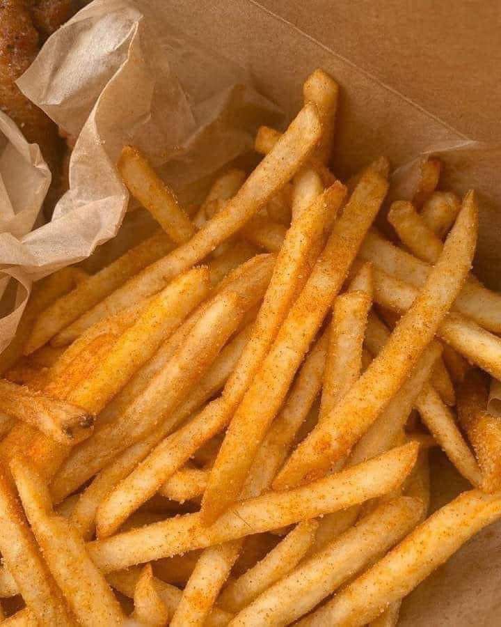 some french fries are in a brown box