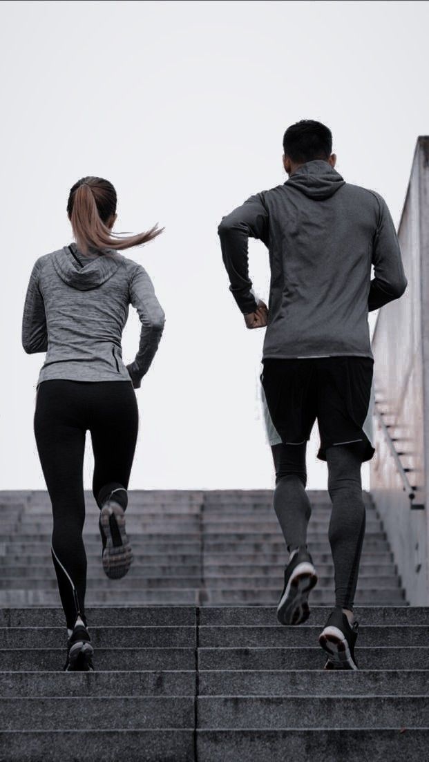 two people are running up some stairs