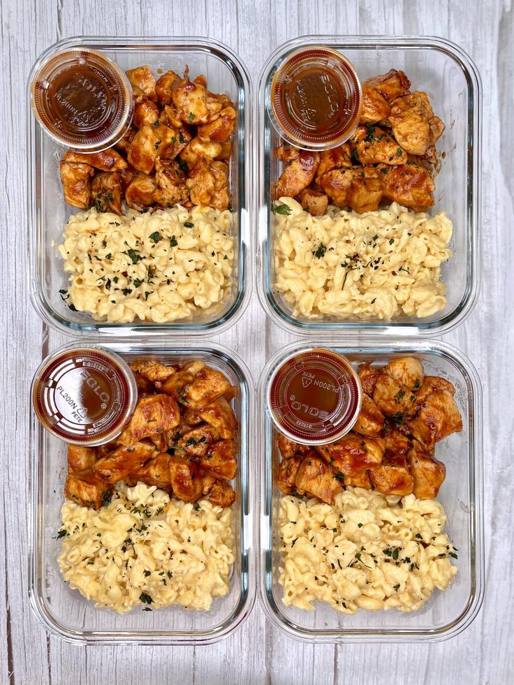 four plastic containers filled with different types of food