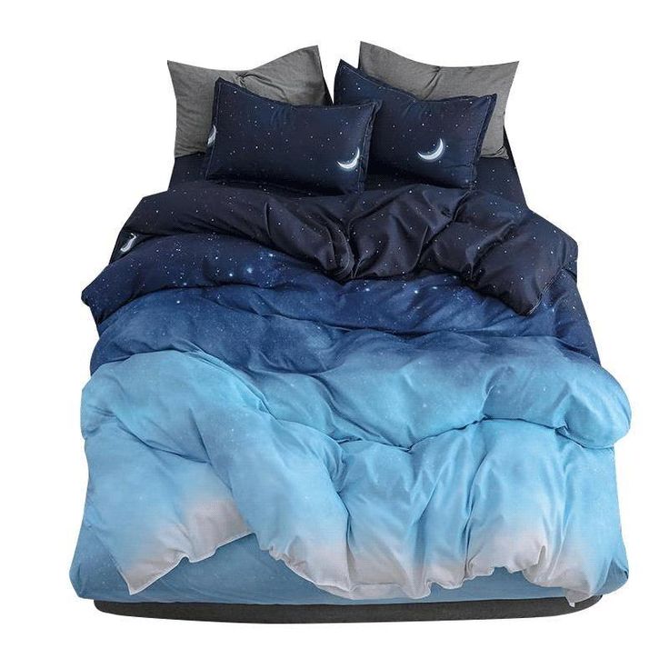 a bed with blue and white comforters on top of it in front of a white background