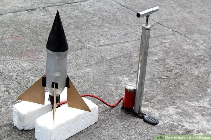 a small model rocket sitting on top of cement