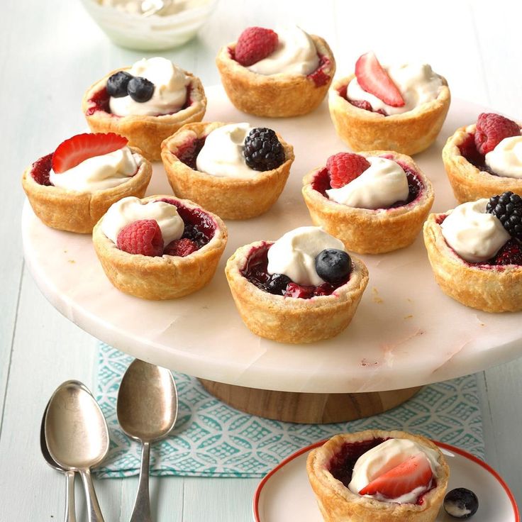 small desserts are arranged on a cake plate