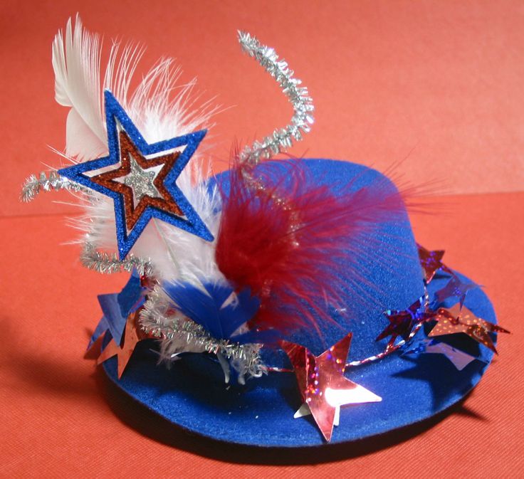 a blue hat with red, white and blue feathers