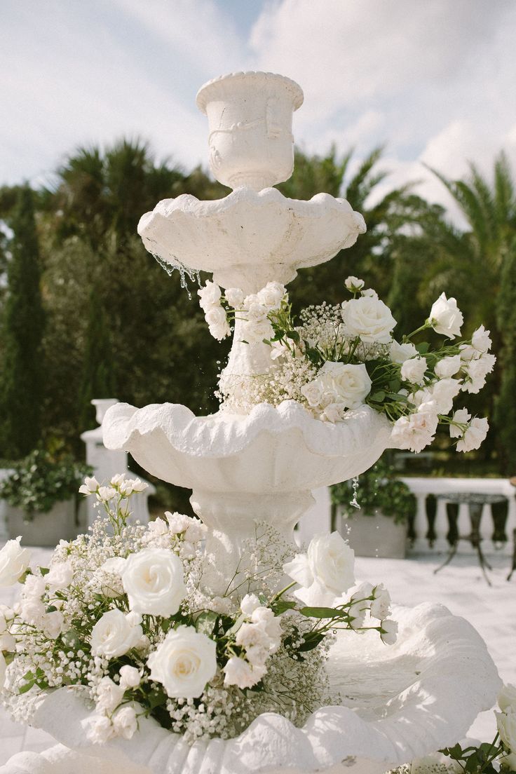 a white wedding cake with flowers on top