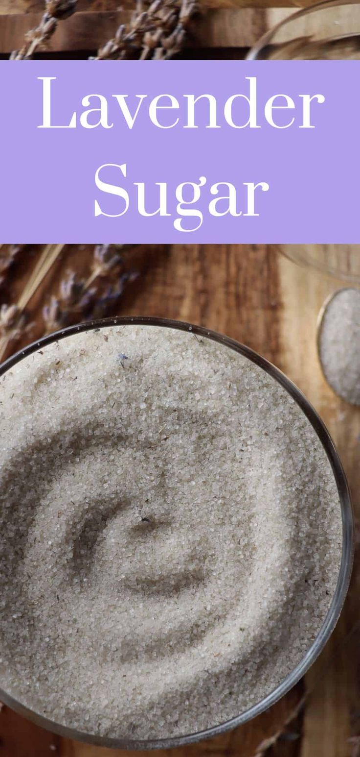 lavender sugar in a glass bowl on top of a wooden table