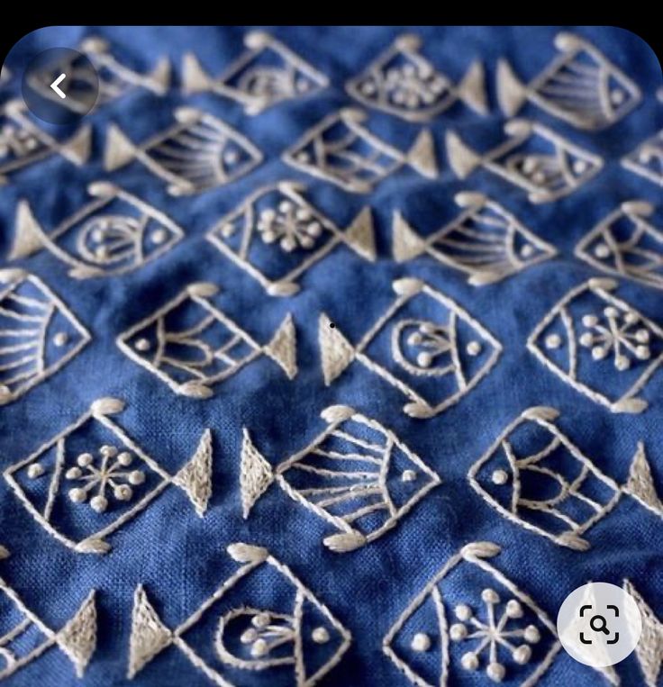 an embroidered blue cloth with silver designs on it