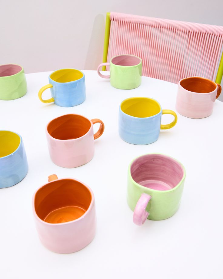 colorful cups sitting on top of a white table