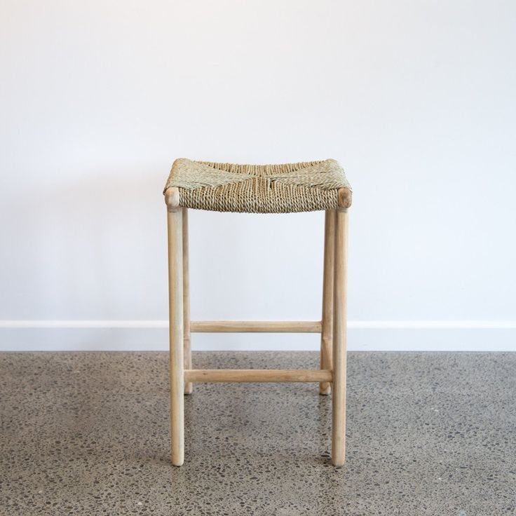 a wooden stool sitting on top of a floor