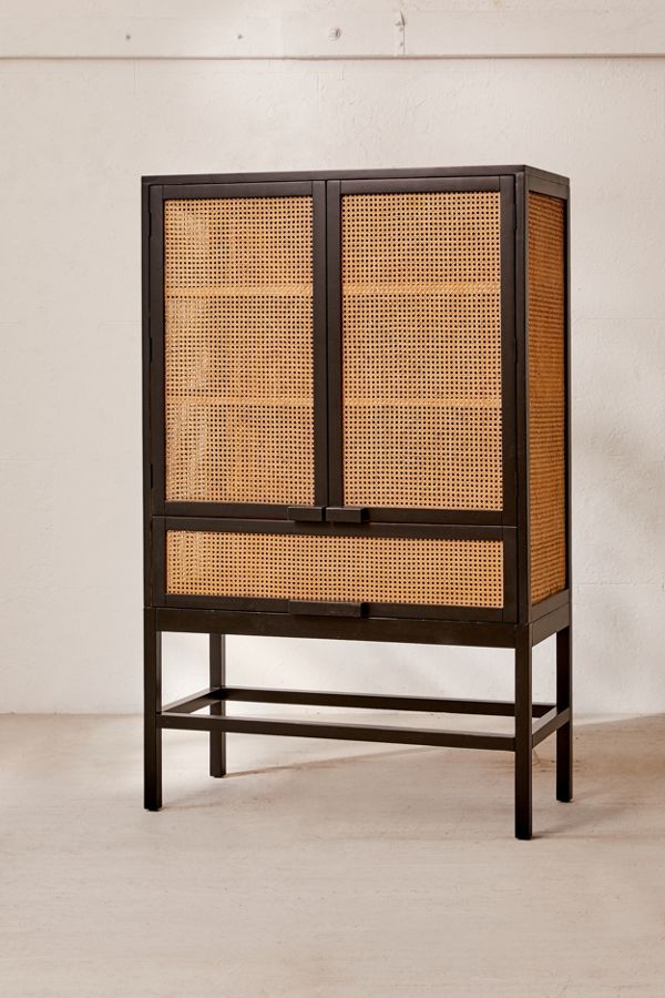 a tall cabinet made out of wood and wicker with two doors on each side