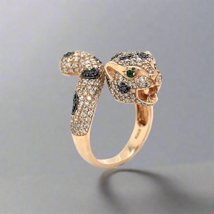 This stunning ring from the Effy Panther Collection is sure to make you stand out in a crowd! This ring contains 1.75 carats of stunning round cut diamonds, and two striking round cut emeralds as eyes. The stunning gemstones are set in 14k rose gold. This ring is the perfect anniversary, birthday or Christmas gift! Metal Type : 14k Rose Gold Ring Size : 7 Brand : Effy Side Stone 1 : Stone Type : Diamond Side Stone 1 : Shape : Round Side Stone 1 : Stone Weight : 1.75 ctw Side Stone 2 : Stone Type : Emerald Side Stone 2 : Shape : Round Side Stone 2 : Stone Weight : 0.03 ctw Side Stone 2 : Quantity : 2 Jewelry Style : Ring Anniversary Gemstone Snake Ring, Luxury Formal Gemstone Snake Ring, Luxury Multi-stone Rose Gold Jewelry, Elegant Multi-stone Cubic Zirconia Emerald Ring, Luxury Gemstone Snake Ring, Panther Ring, Bridesmaid Gifts Jewelry, 14k Rose Gold Ring, Rose Gold Diamonds