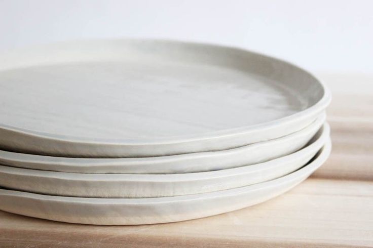 four white plates stacked on top of each other