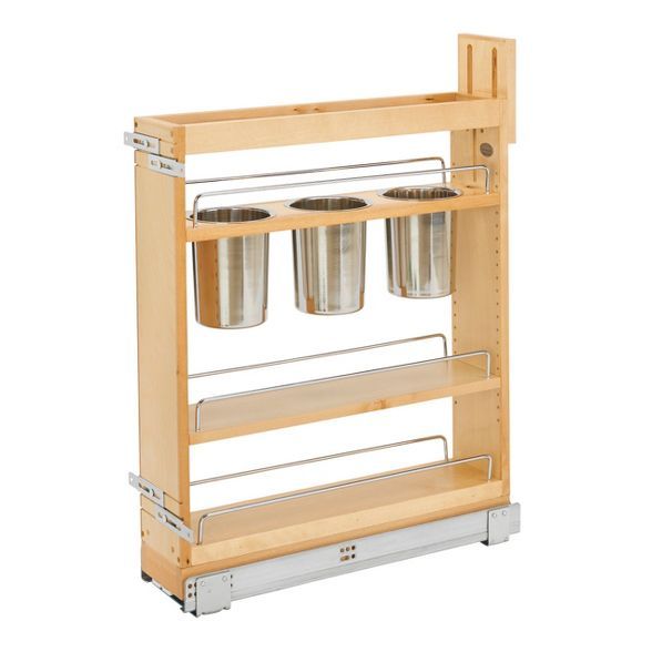 a wooden shelf with three metal buckets on it