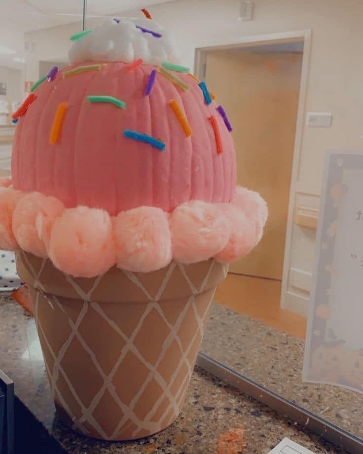 an ice cream cone with sprinkles on it sitting on a counter top