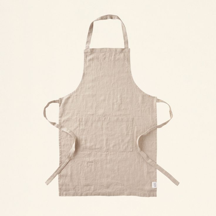 the apron is made from linen and has two straps on one side, while the other end