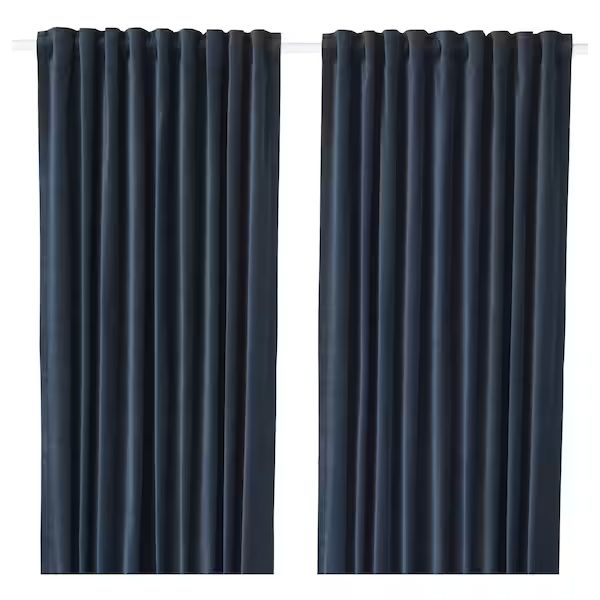 two dark blue curtains hanging on a white wall