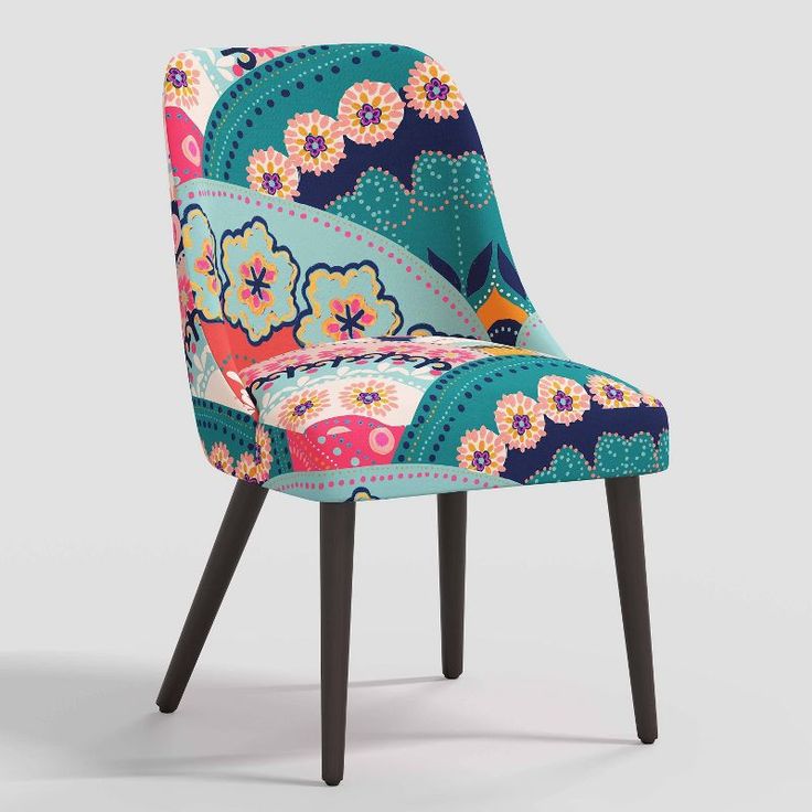 an upholstered chair with colorful flowers on the back and legs, against a gray background