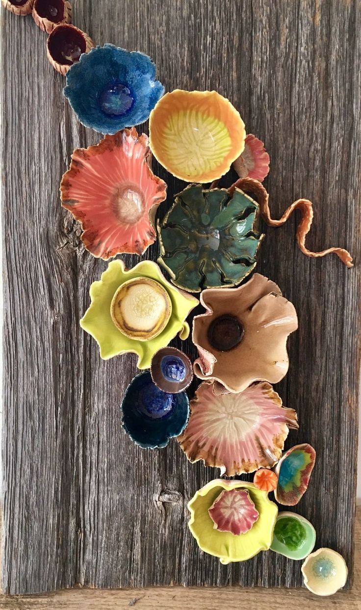 several colorful bowls are arranged on a wooden surface