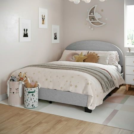 a child's bedroom with pink walls and white furniture