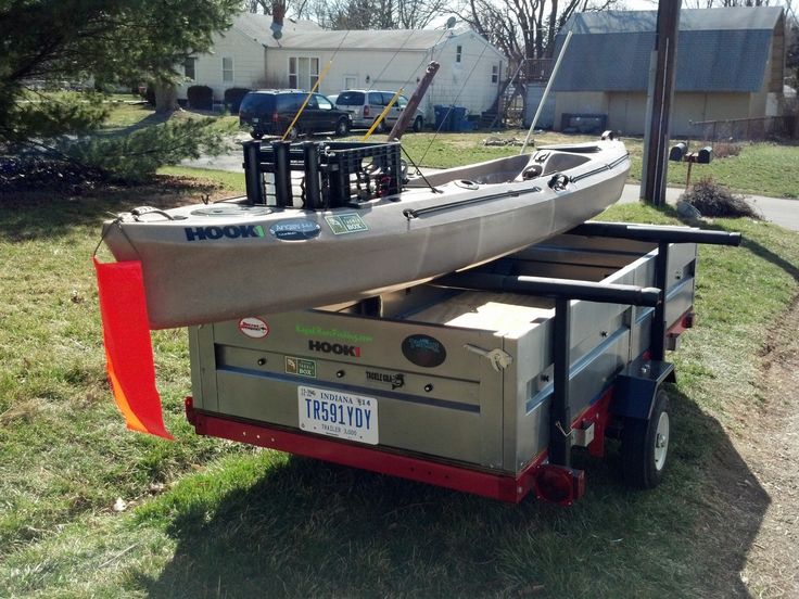 a boat is on the back of a trailer with its kayak attached to it