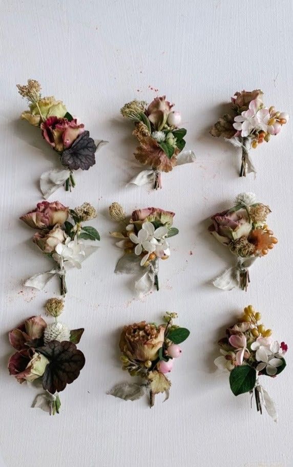 a bunch of flowers that are sitting on a table together, all in different shapes and sizes